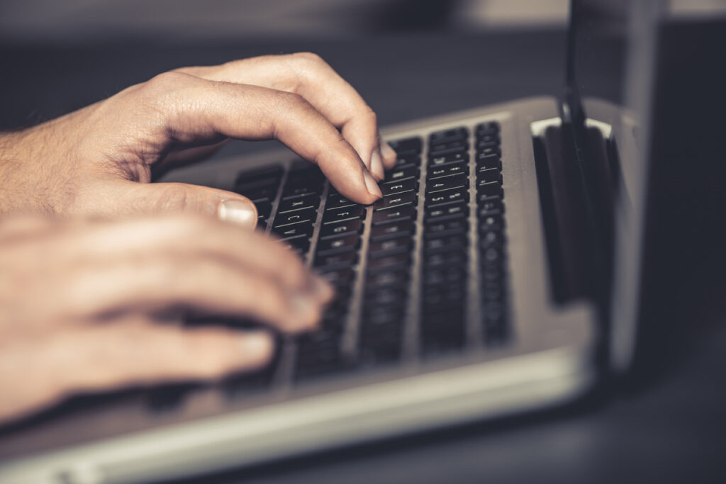 A man working on his laptop to reduce human error in computer security