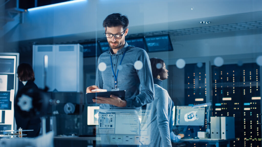 Male IT professional using a tablet device to assess a business' cmmc compliance.