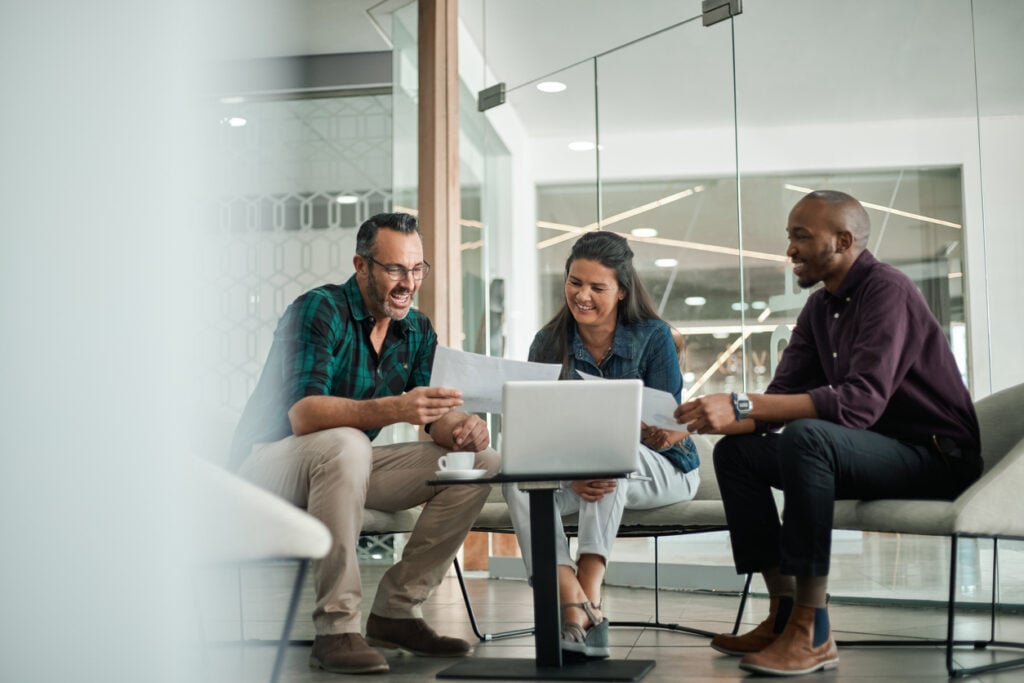 Group of diverse lawyers in a law firm discussing their clients' information - using cybersecurity measures to secure sensitive information.