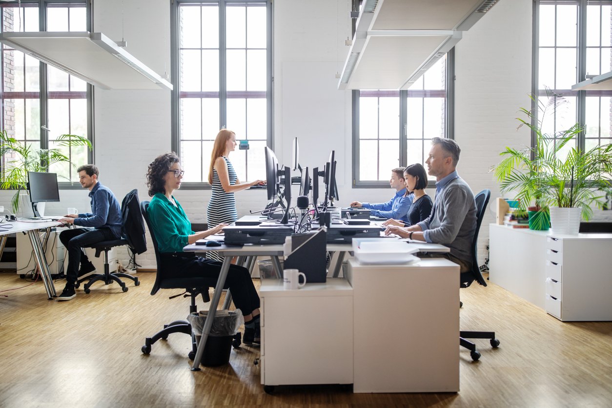 Employees working on their desks in an office.