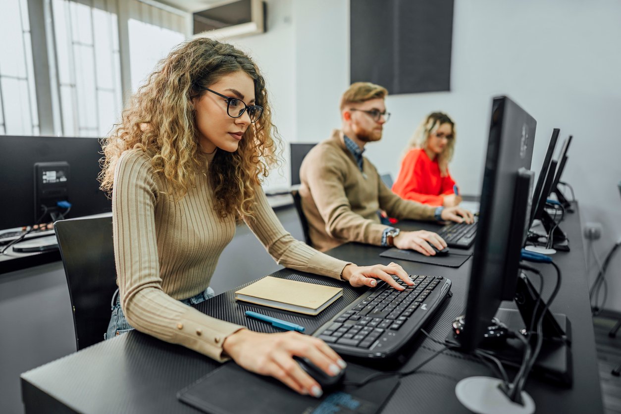 Group of employees using computers during a cybersecurity awareness training.