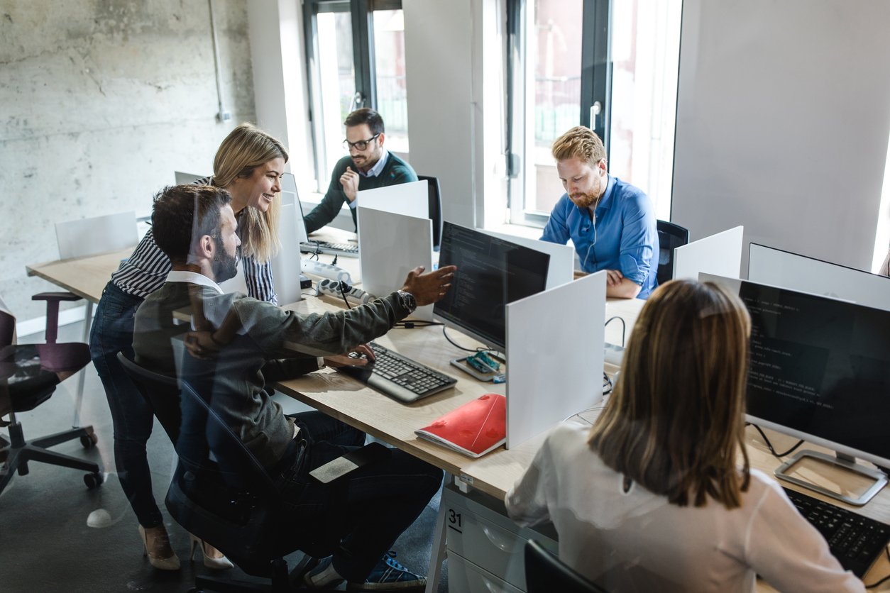 Large group of computer programmers working in the office.