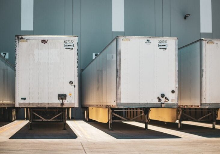 A row of semi trucks parked next to each other