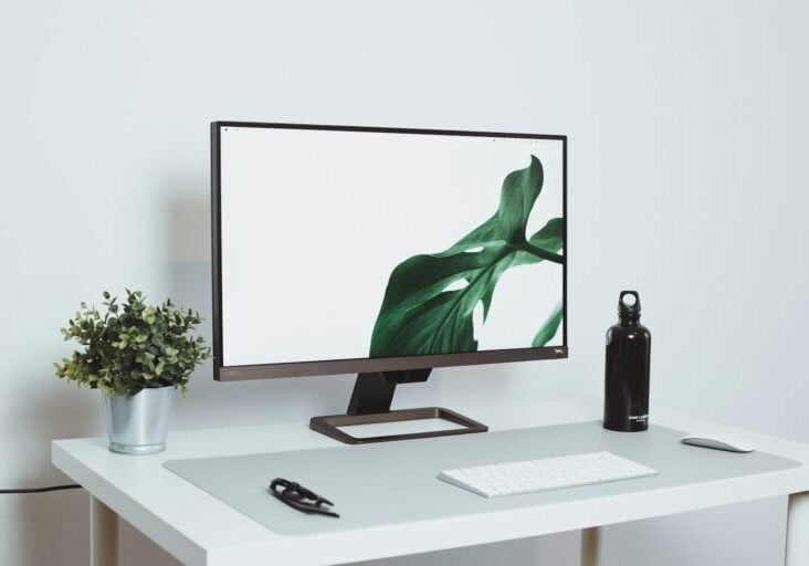 a computer monitor sitting on top of a white desk
